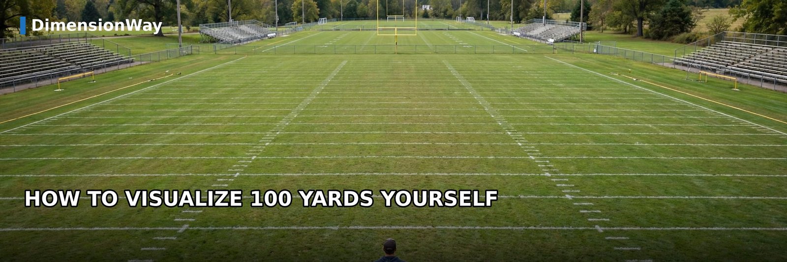 A person standing at the goal line of an empty American football field looking down the field to visualize 100 yards.