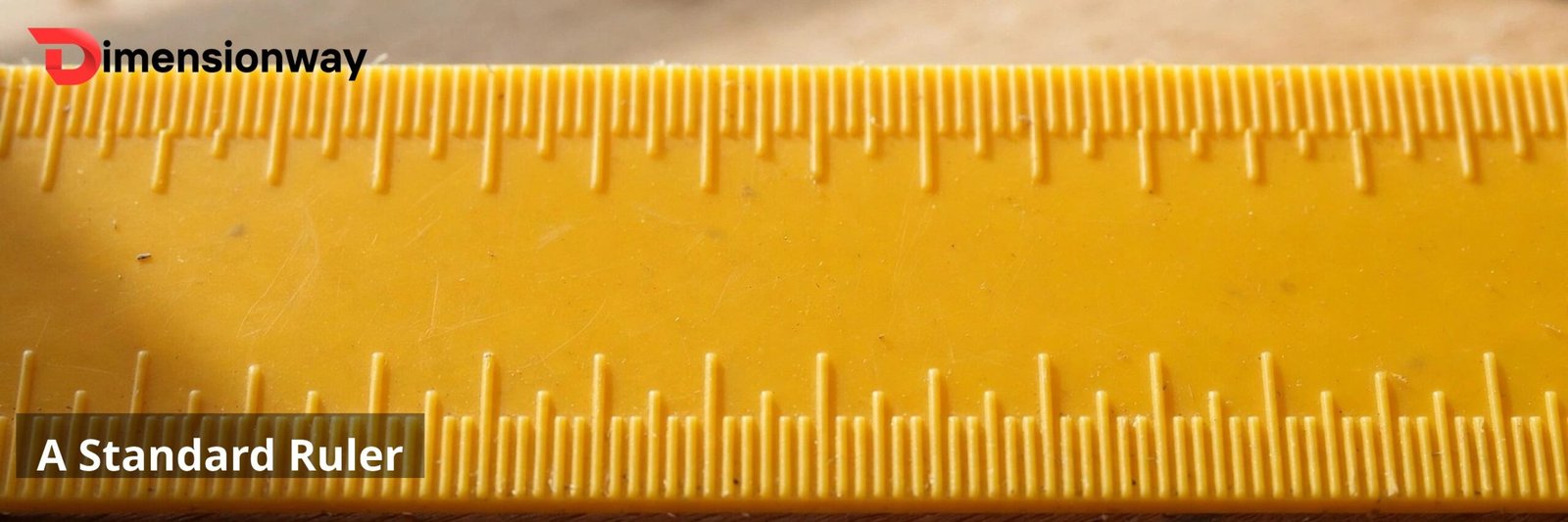 A yellow plastic school ruler close up on a desk.
