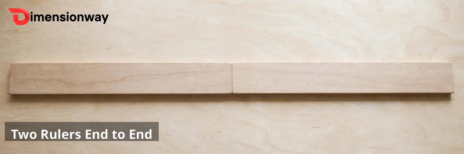 Two wooden rulers laid end to end on a desk.
