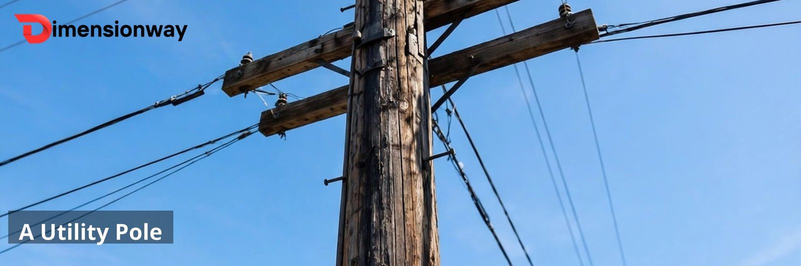 A tall wooden utility pole with crossarms and wires seen from below against the sky.