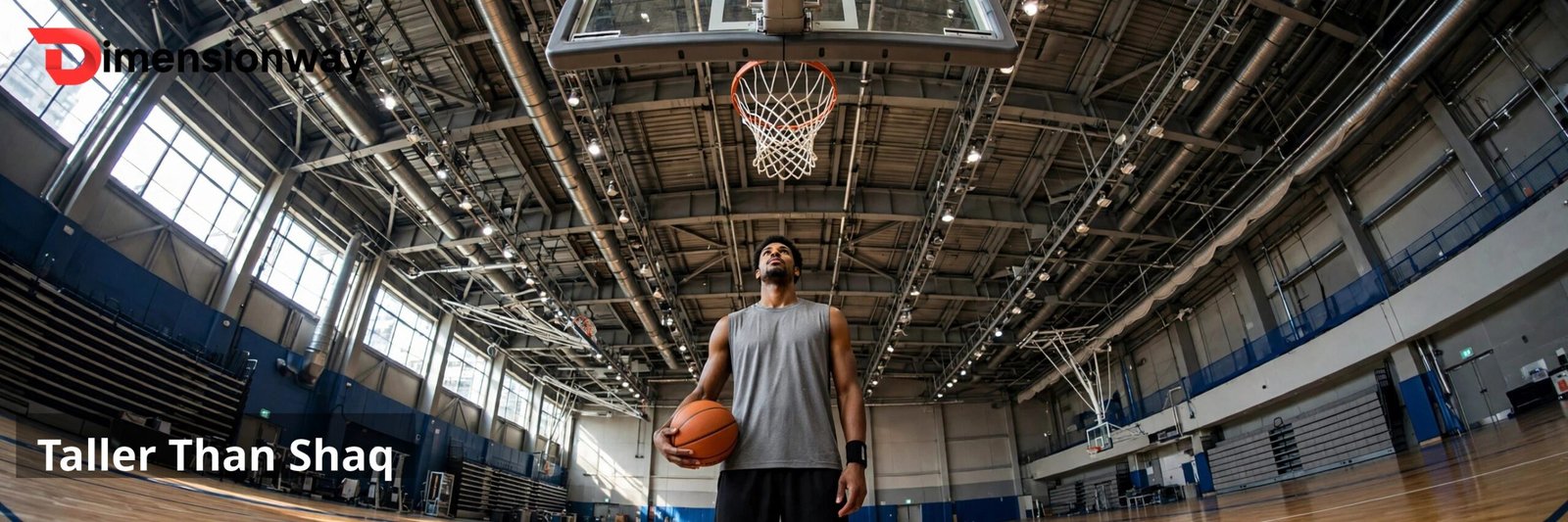 A very tall basketball player standing under a hoop holding a basketball.