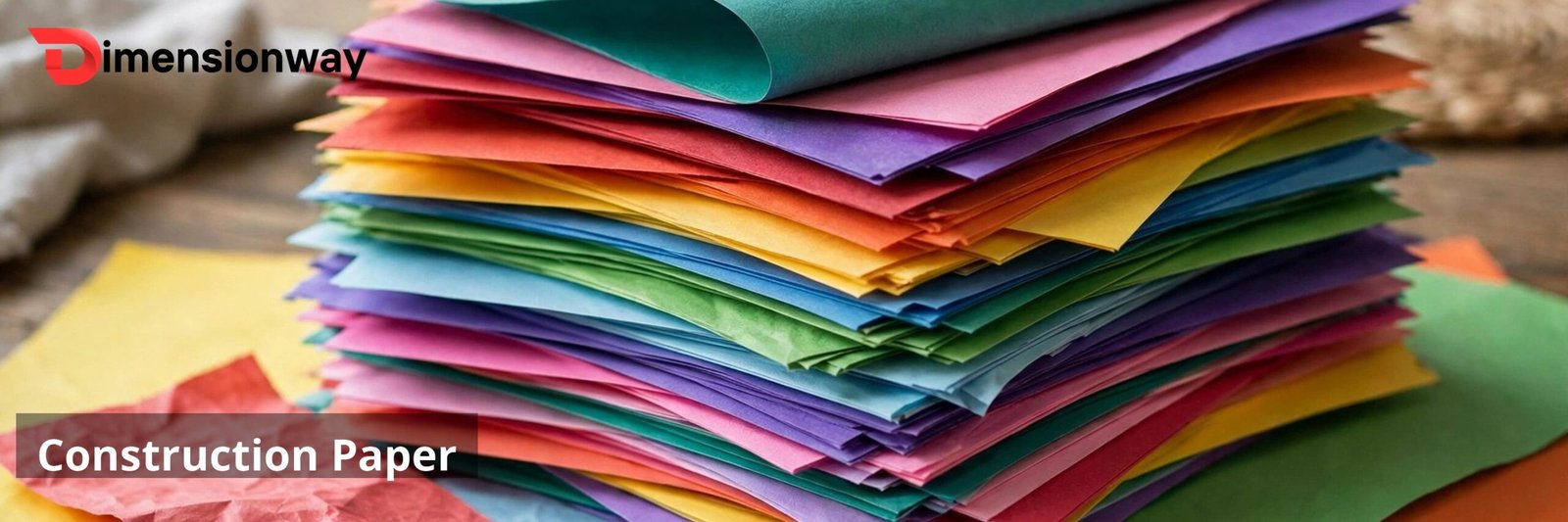 Colorful sheets of construction paper stacked on a table.