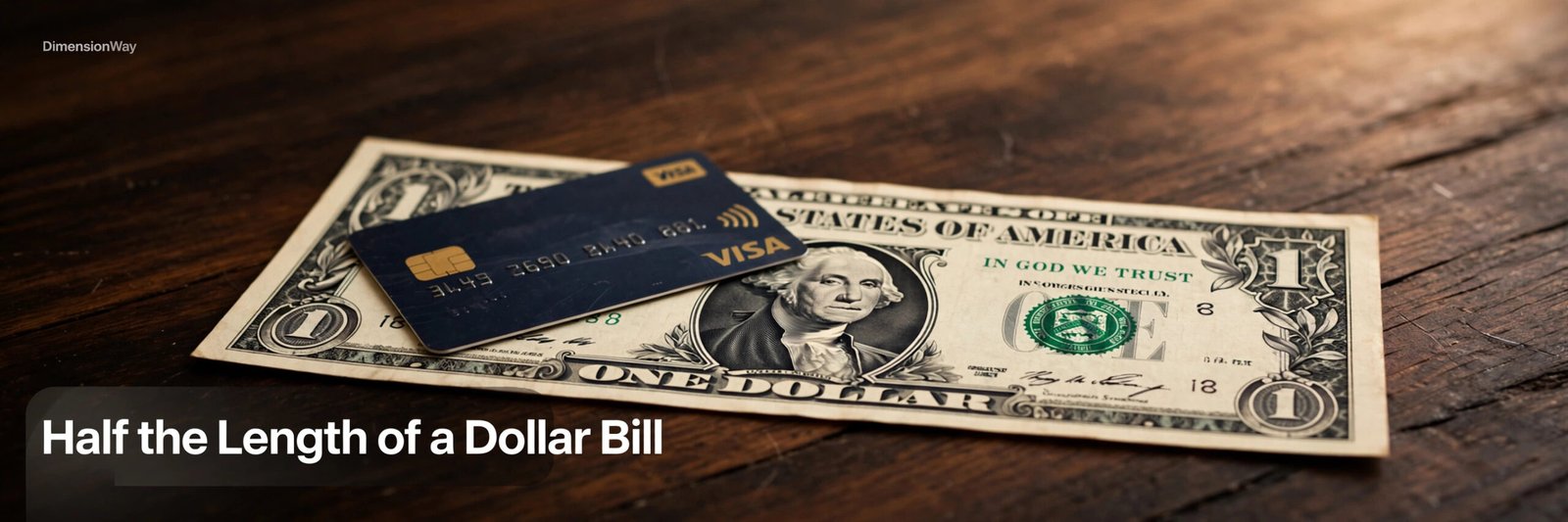 A credit card lying on top of a US dollar bill on a dark wooden table.