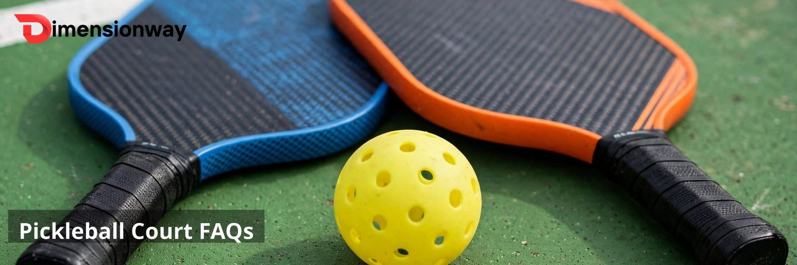 Pickleball paddles and ball on a court.